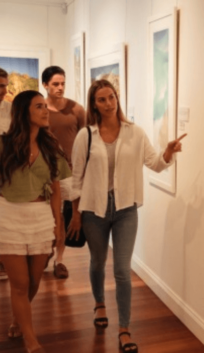 people browsing artworks in gallery