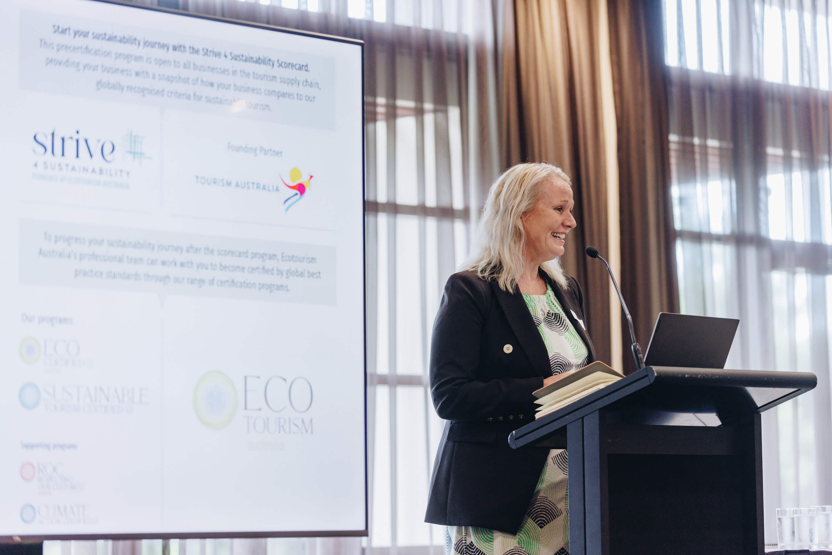 the ceo of ecotourism australia presenting a new sustainable program at lecturn