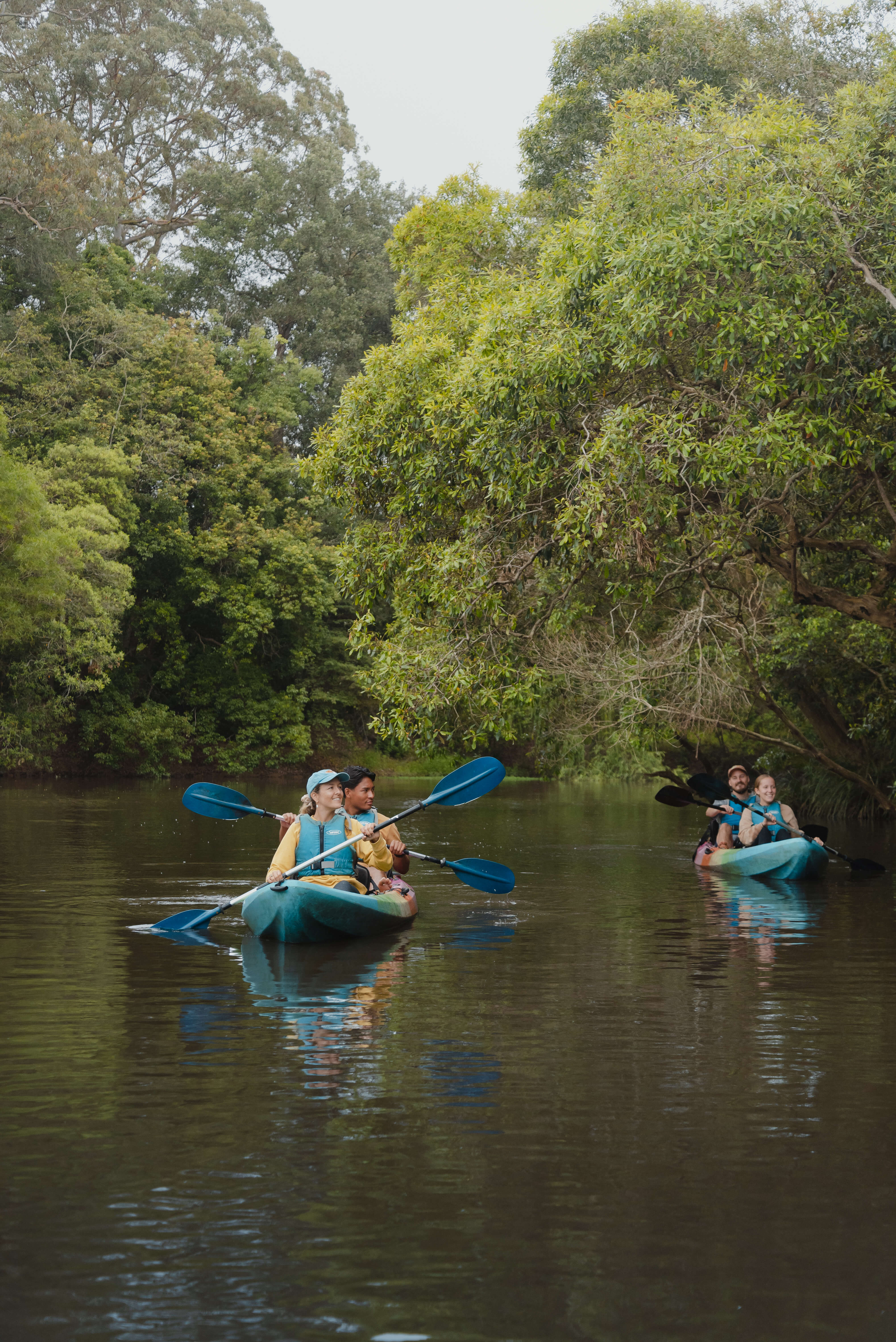 group paddling down a creek