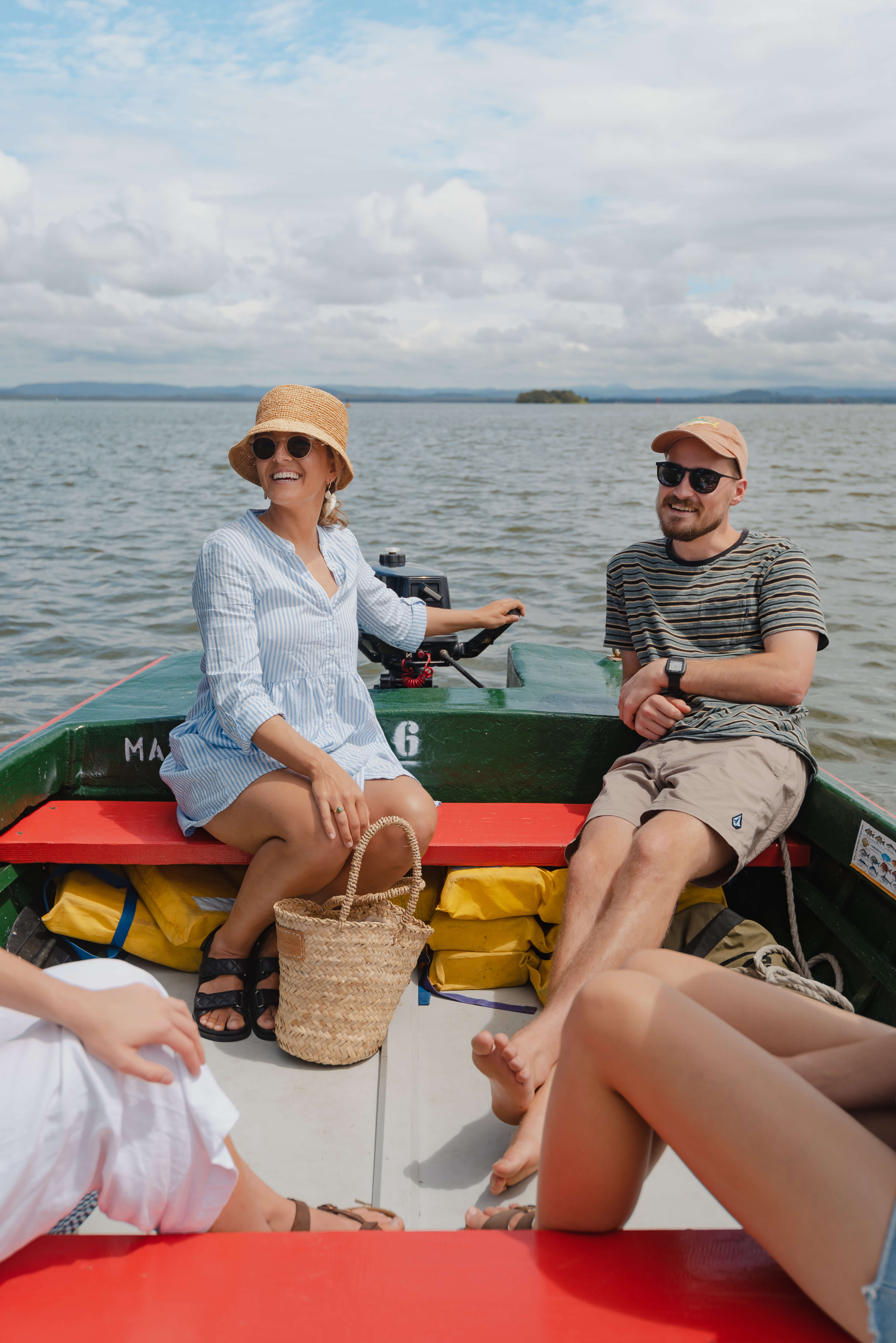 group of tourists depart on boat on lake happily