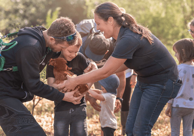 People hoding a chicken at grace Springs farm Central Coast