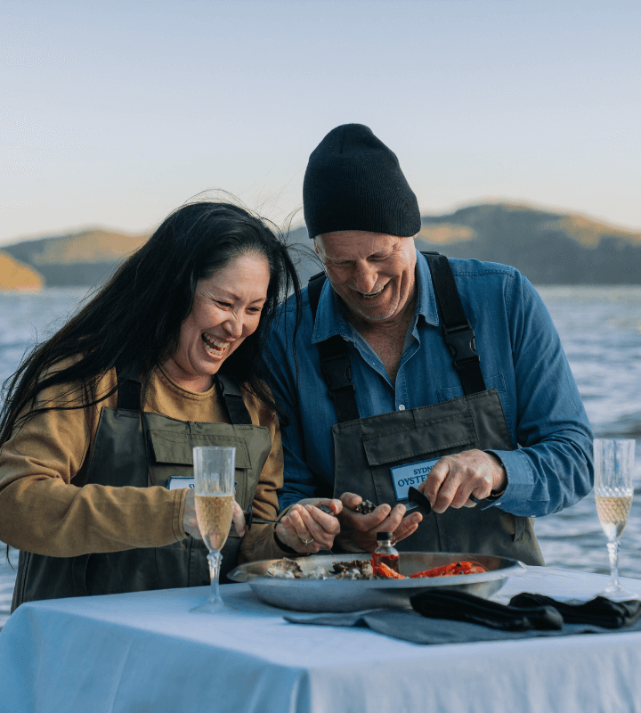 Couple wearing fishing wadders in a lake