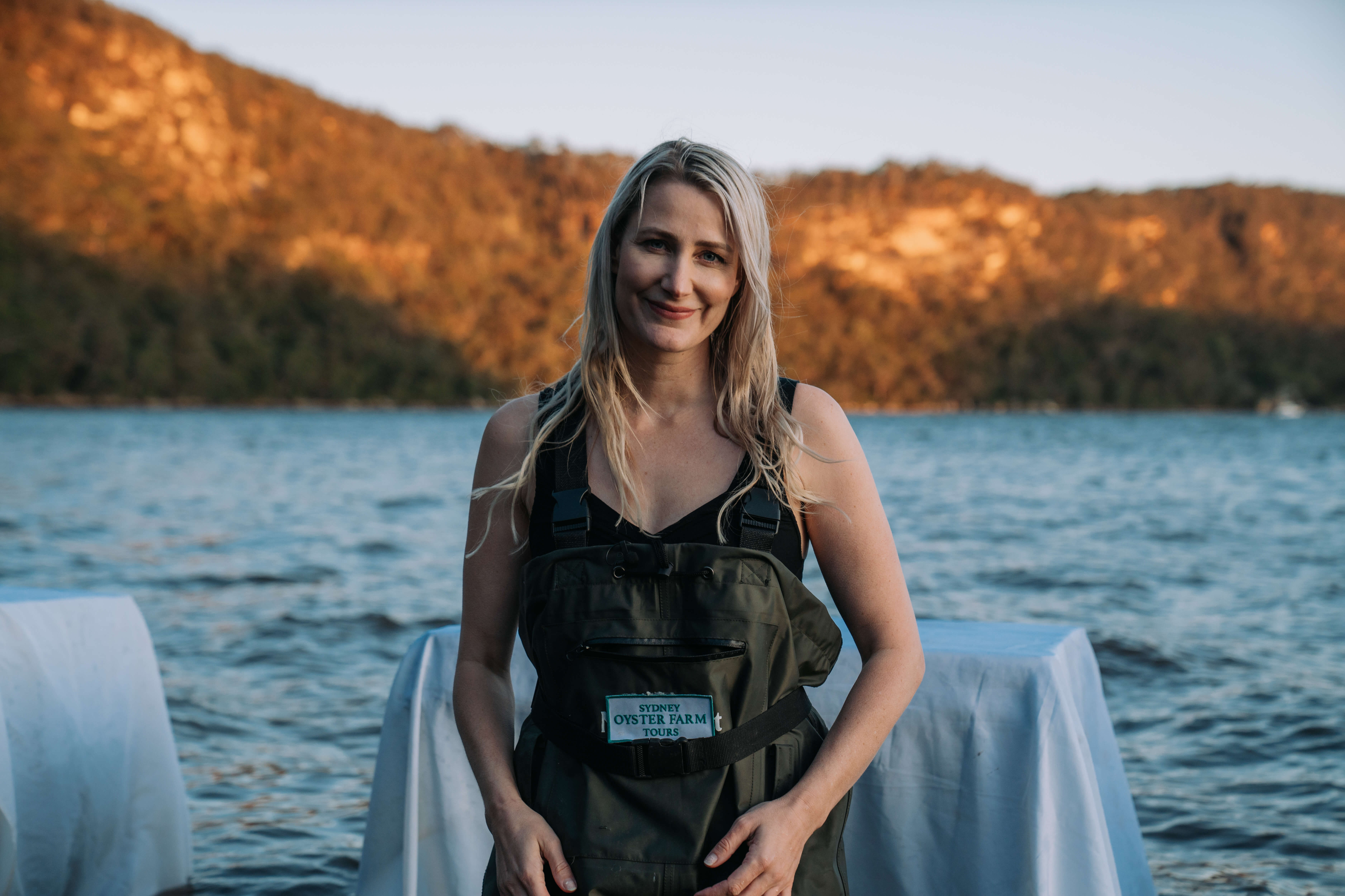 Host of Sydney Oyster Farm Tours with a sunset backdrop