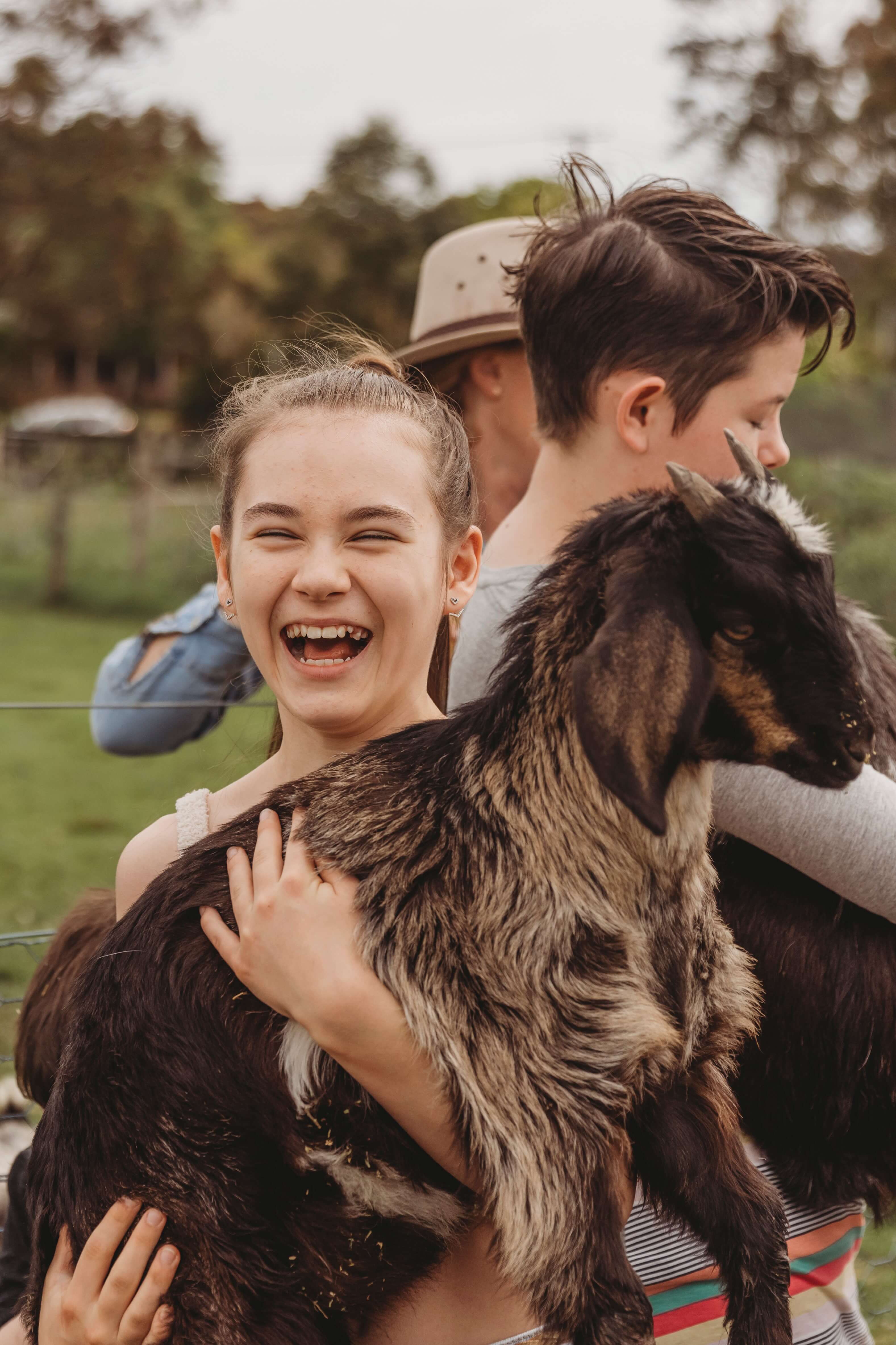 Child holding a young goat