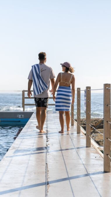 couple walk by ocean bath