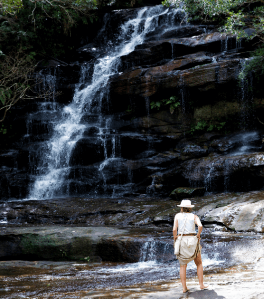 Woman in Brisbane Water National Park admiring a waterfall