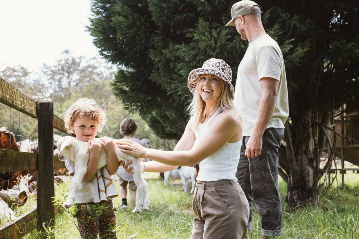 Kyal and Kara with family holding lamb