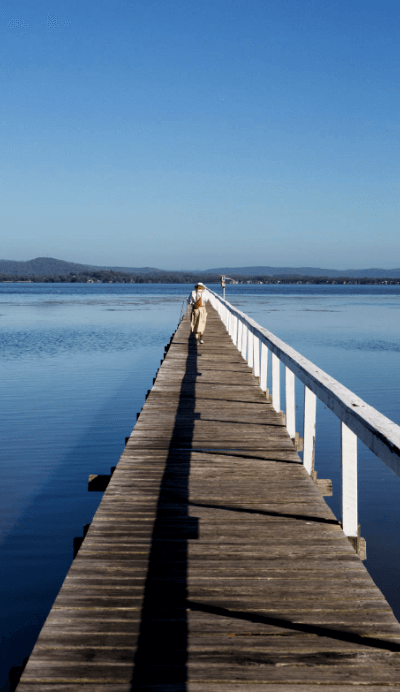 person in distance walking on wharf