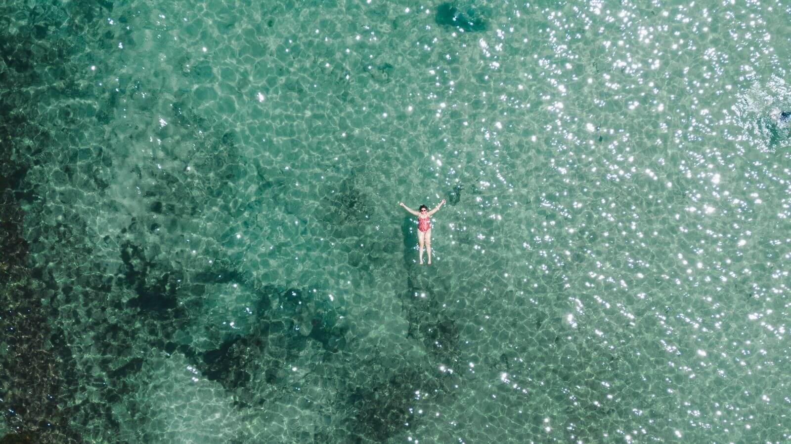 woman floating on turquoise water