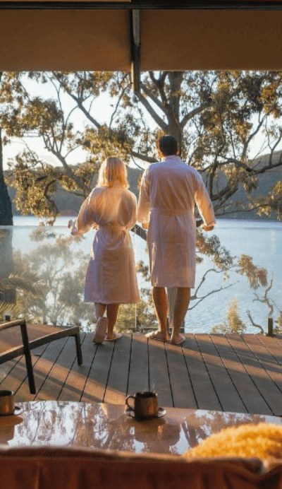 couple in dressing gowns overlooking hawkesbury River at Marramarra Lodge