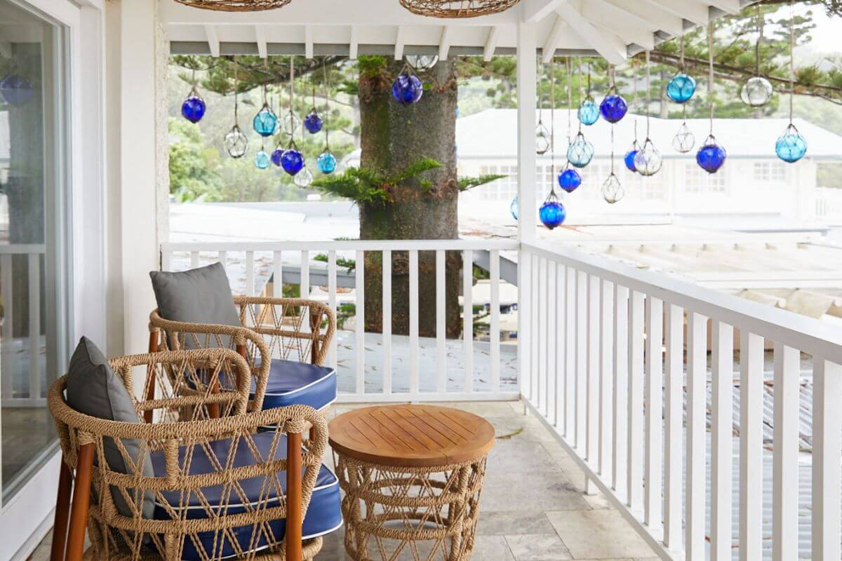 coastal retreat front porch with ocean view and blue baubles hanging above