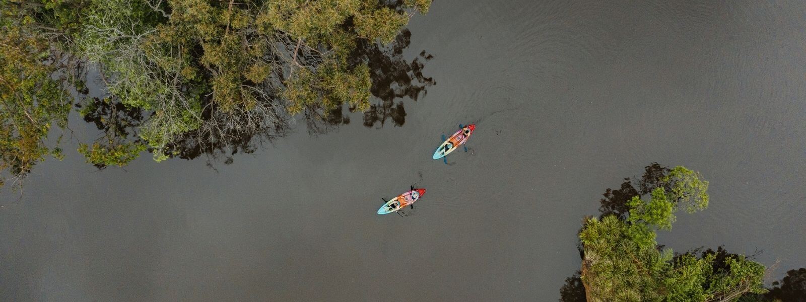 two kayakers explore a national park river