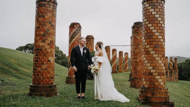 couple in ancient looking pillars setting