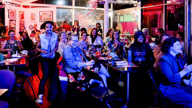 people laughing in a comedy club