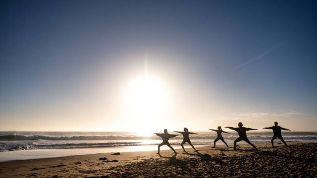 yoga on the beach at sunrise