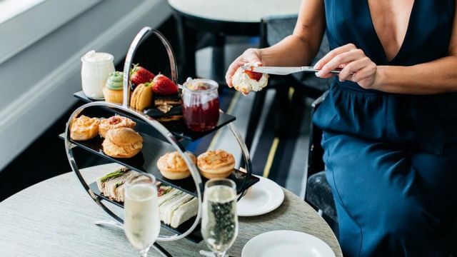 Lady dining with high tea