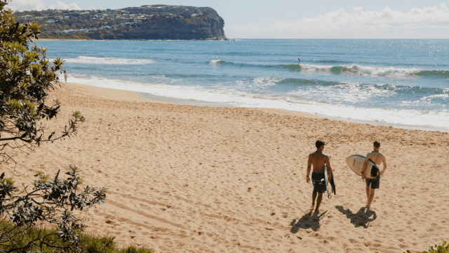 two people heading to surf