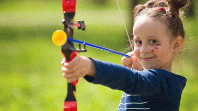 Little girl playing archery