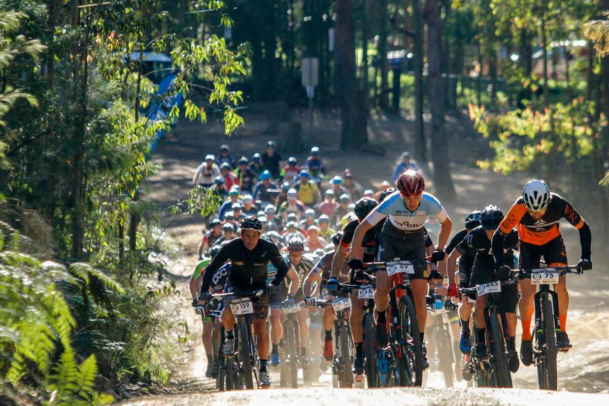 large group of bike riders on dirt track