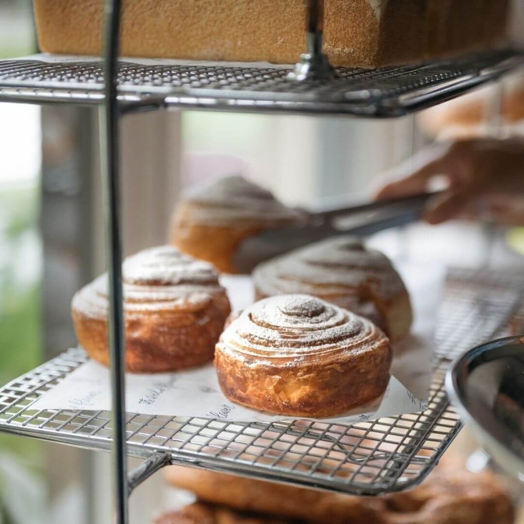 shelves of fresh pastry scrolls dusted with icing