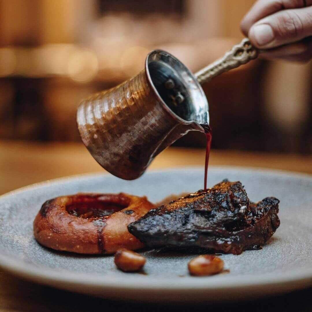 succulent meat dish with gravy being poured over it