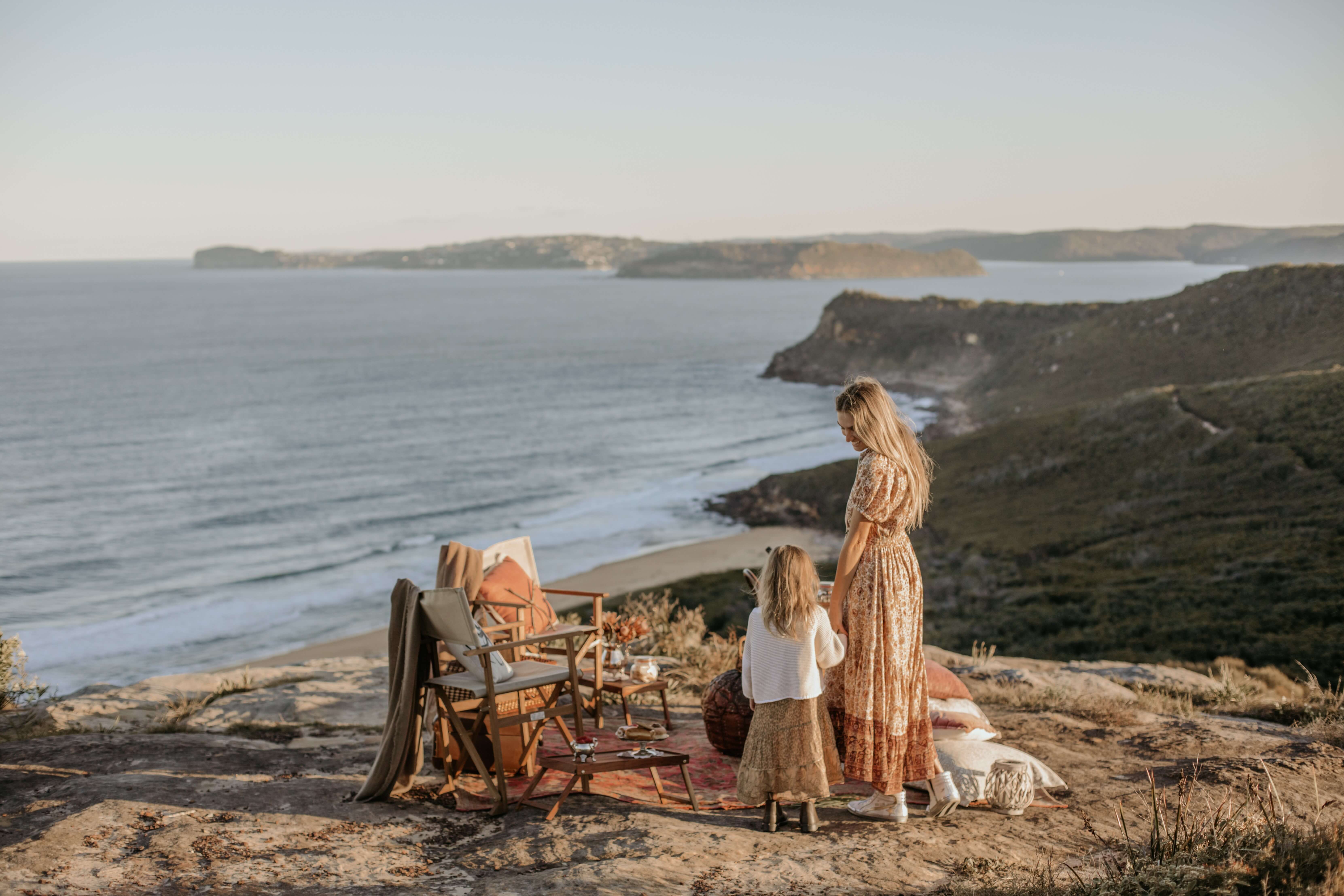 mum and daughter picnic on scenic lookout