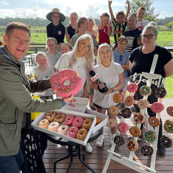 crowd gathered around doughnuts