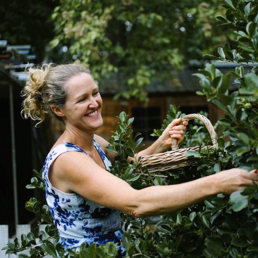 female winemaker pruning tree