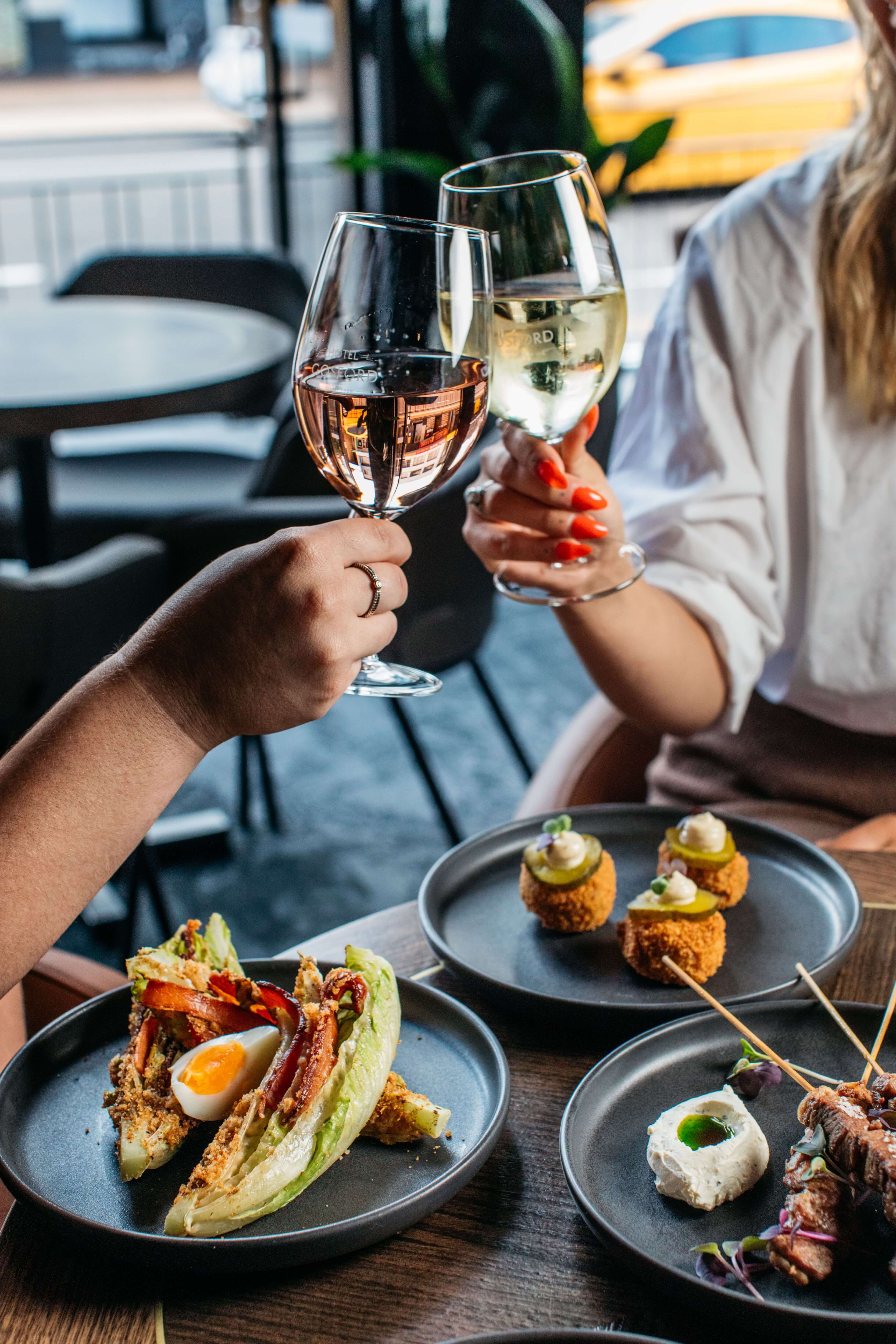 women toasting over pub grub