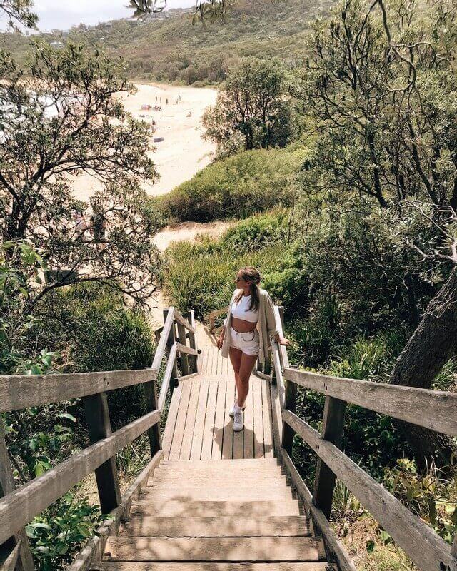 woman on steps to secluded beach