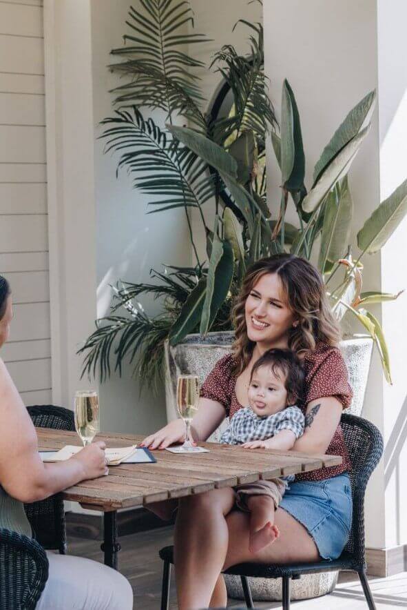 woman and baby sitting in soft pastel pub space