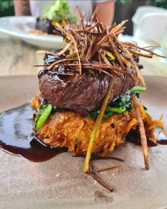 eye fillet with potato rosti, wilted spinach and hoisin green pepper corn jus