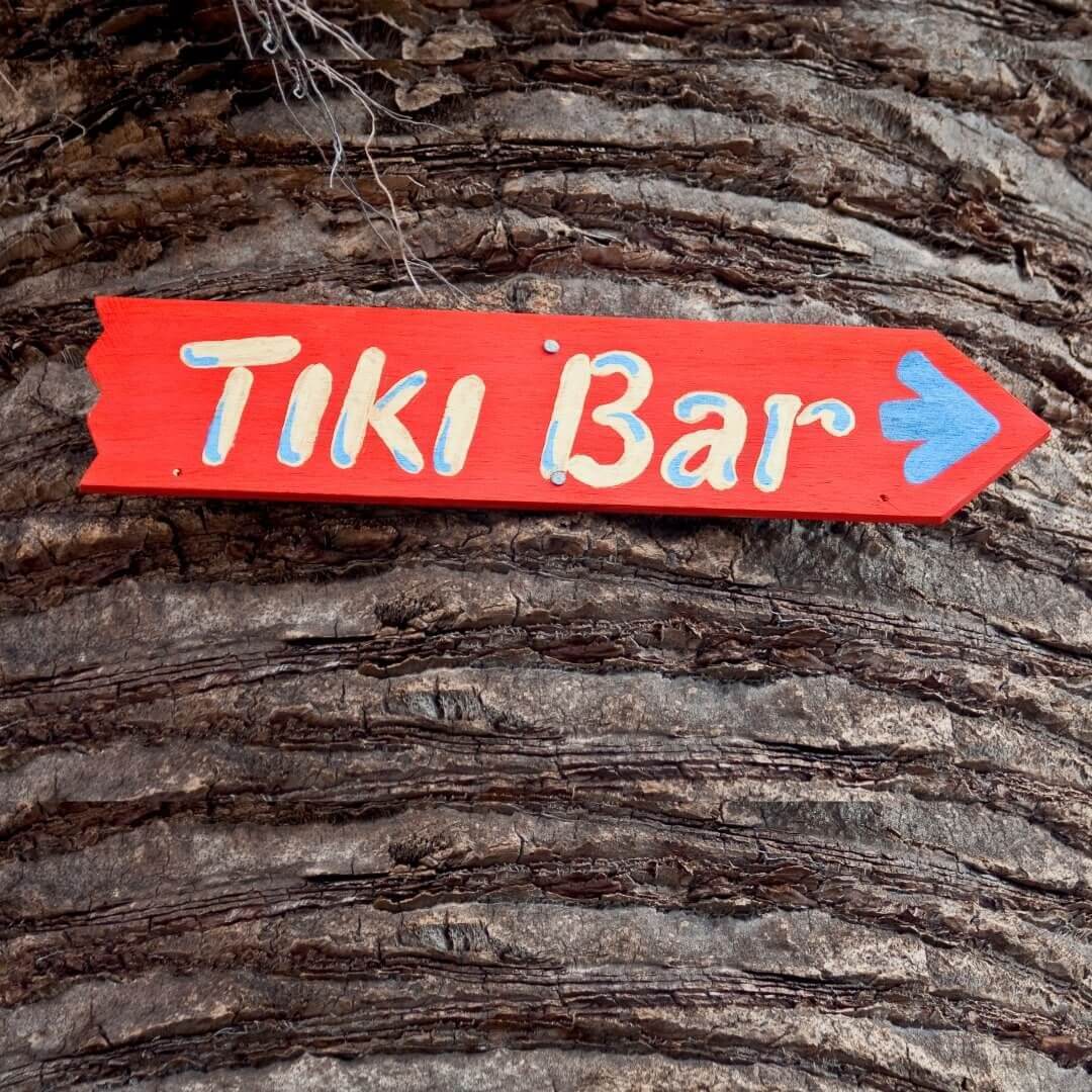 Sign on a palm tree with Tiki Bar