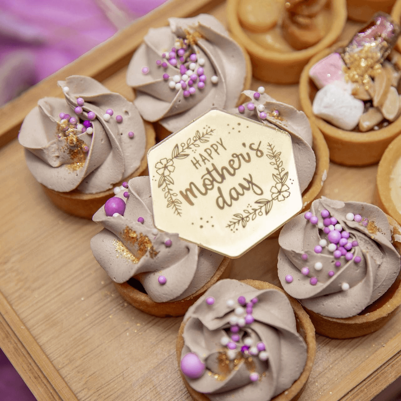 Mother's day sweet tart with chcolate icing and purple flowerss from Teeny Tarts