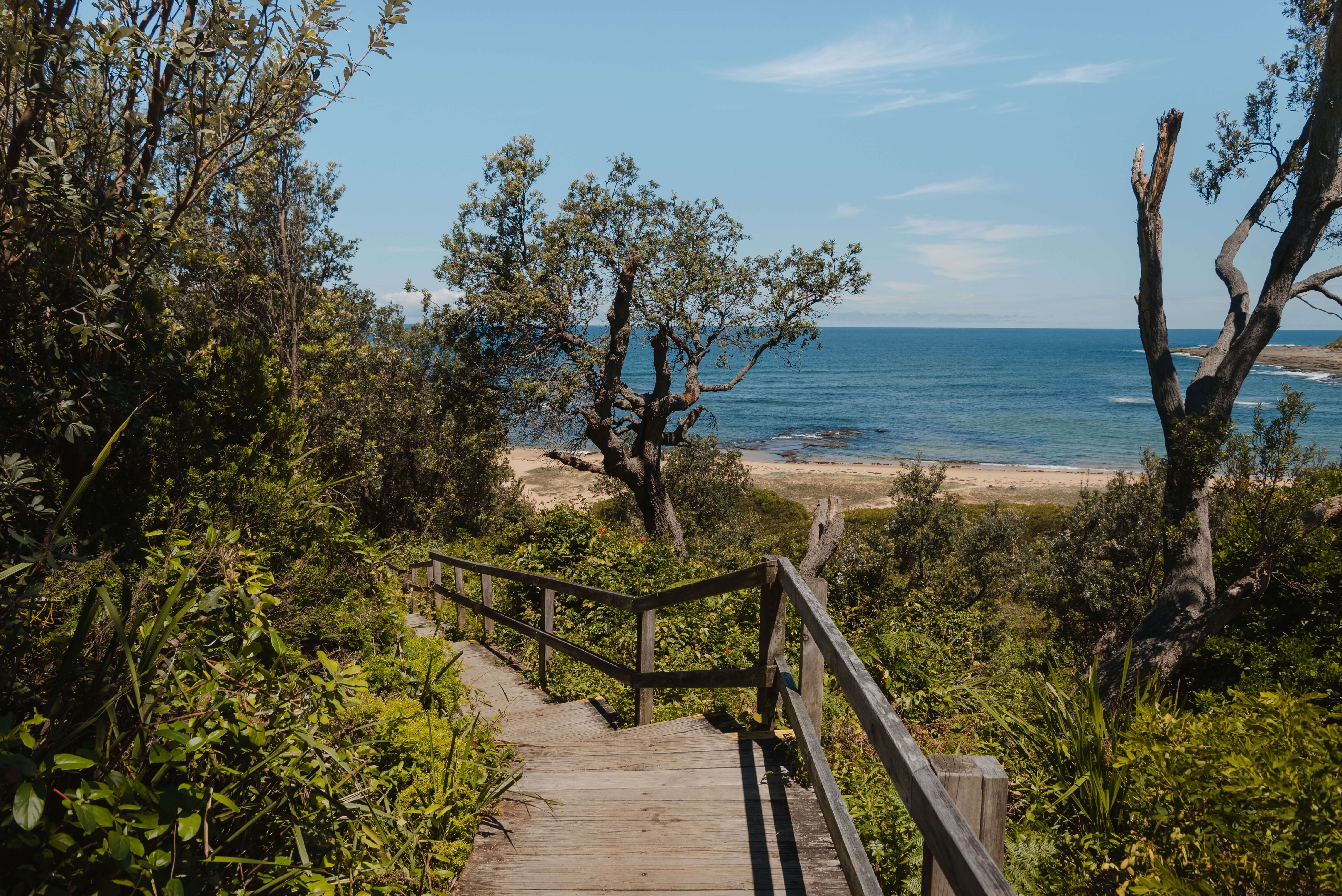A wooden staircase leading to a secluded beach