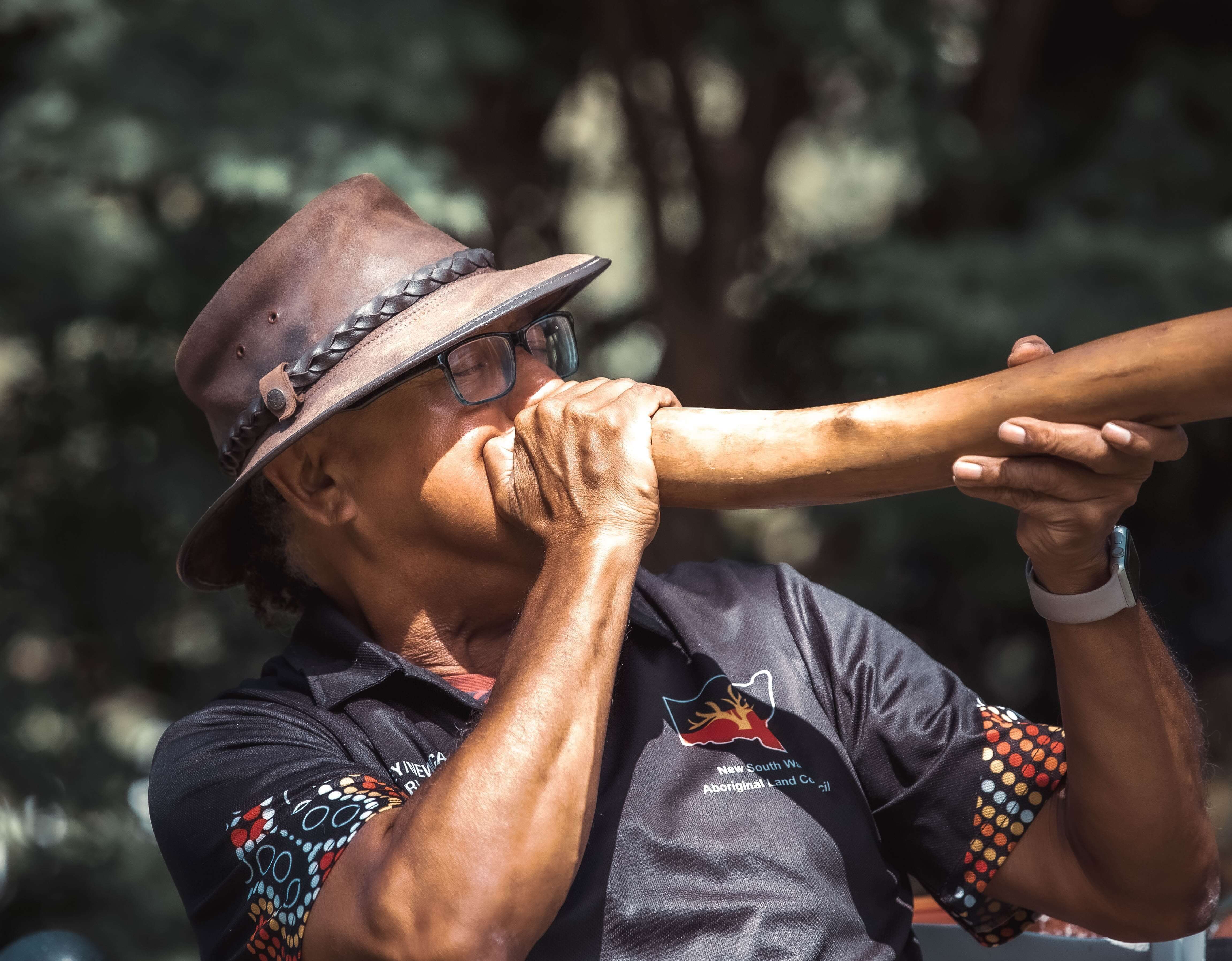aboriginal elder playing didgeridoo
