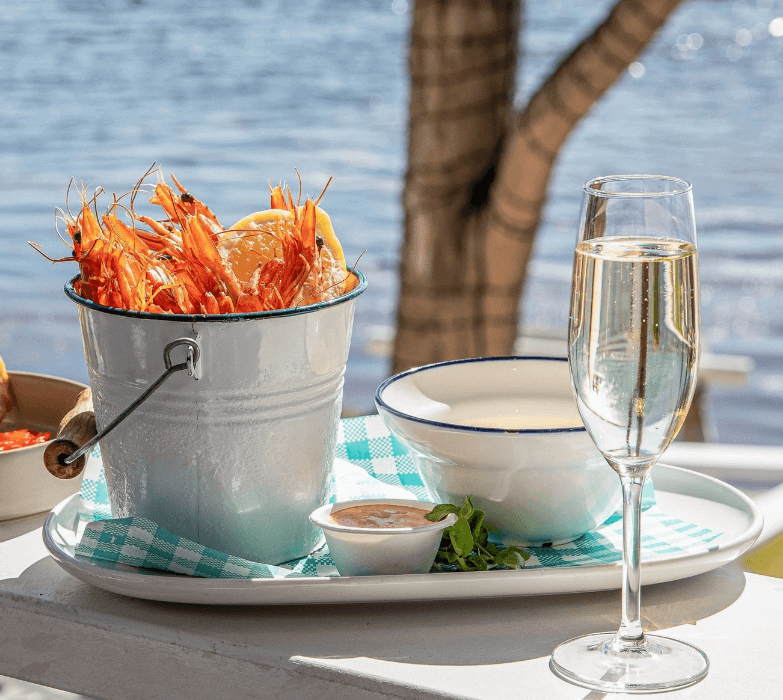 Bucket of Prawns, glass of champagne overlooking the ocean