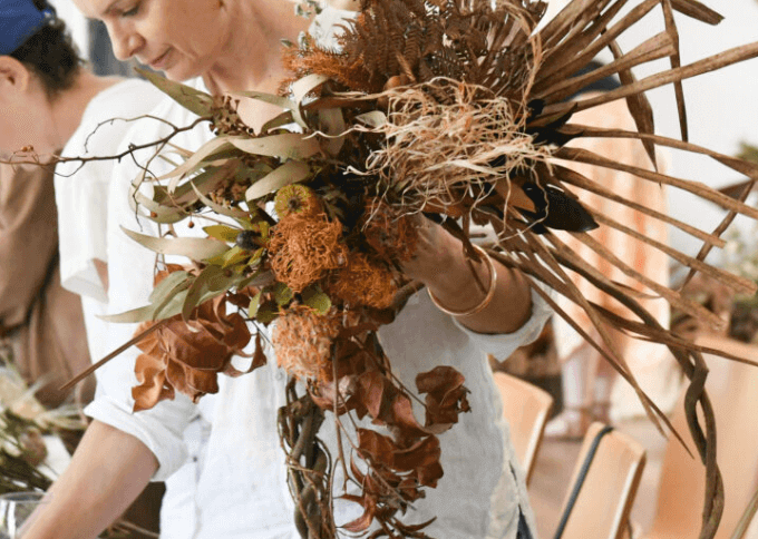 women making Christmas wreath