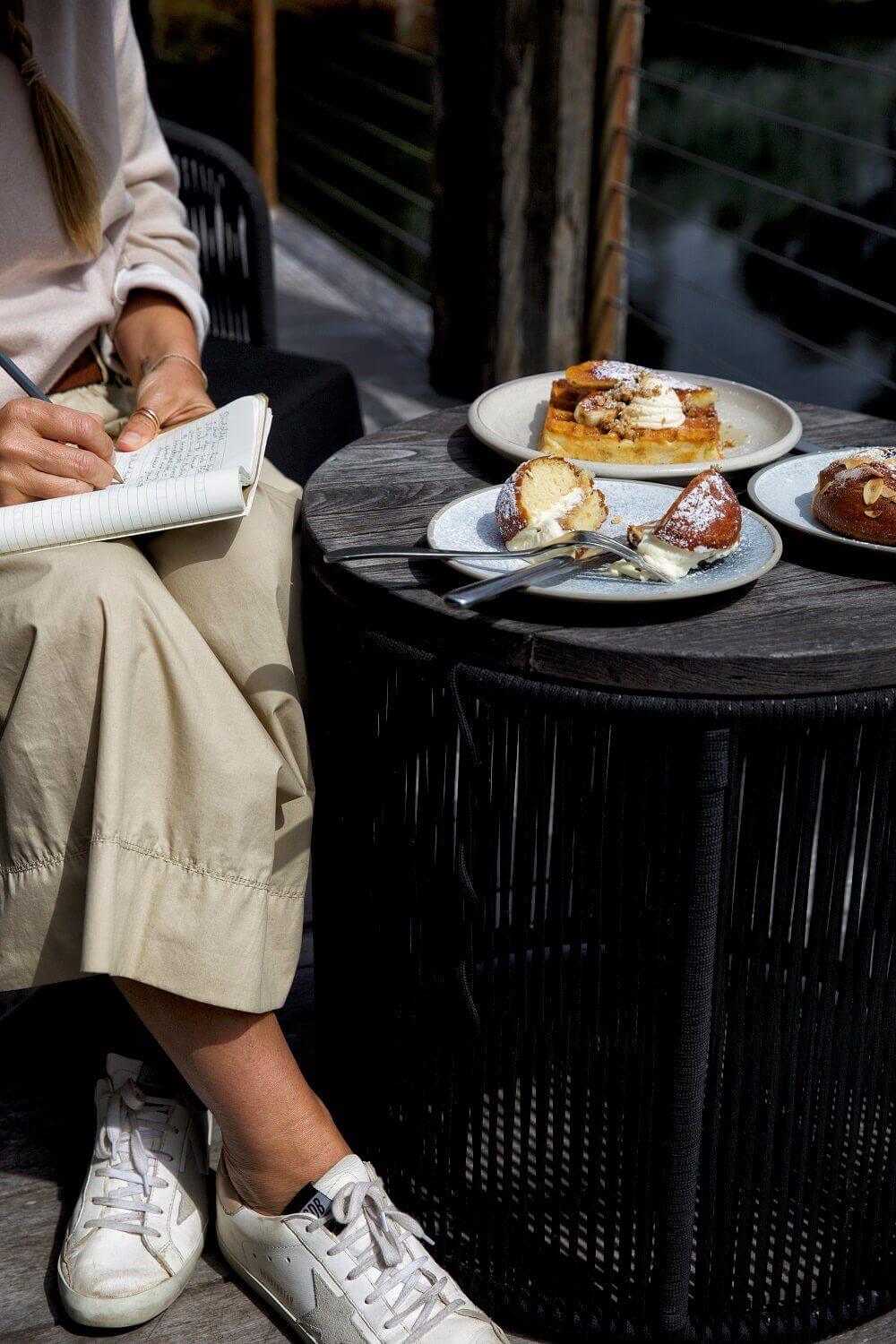 woman taking notes on pastries