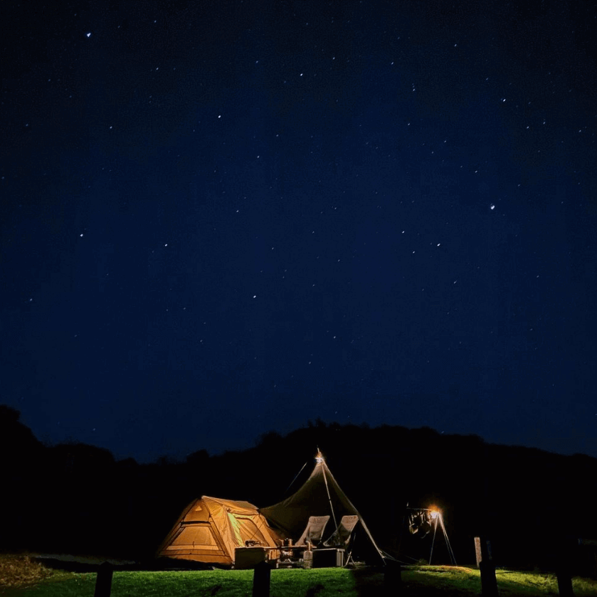 night sky with stars and small tent