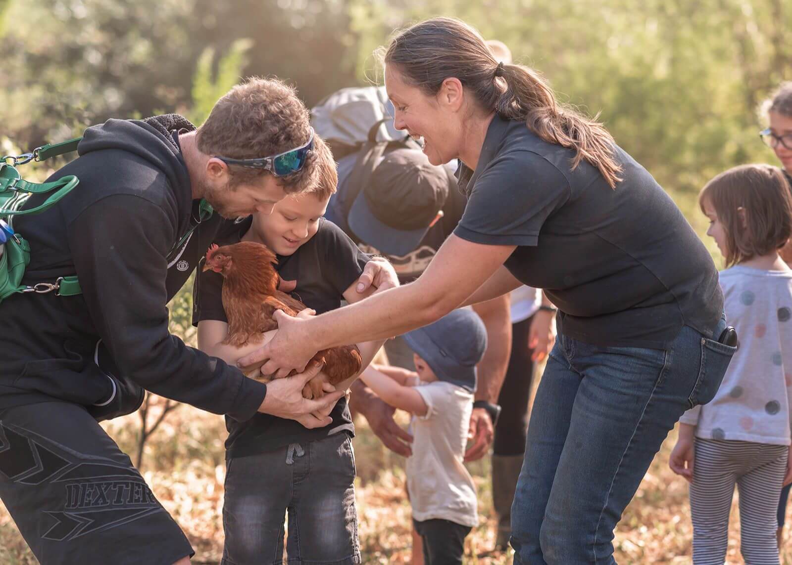 visitors holding a chicken at Grace Springs Farms