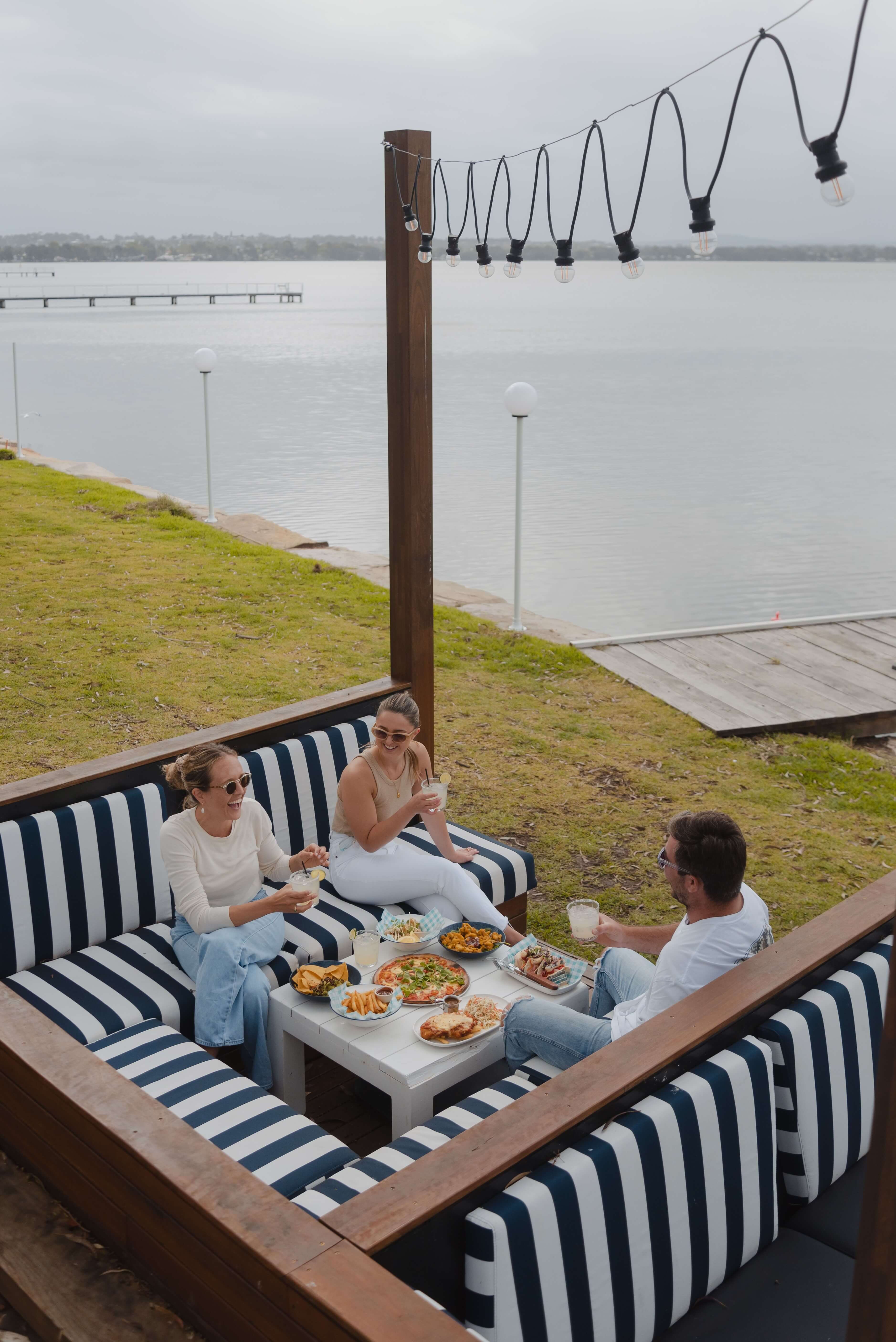 people dining by waterside