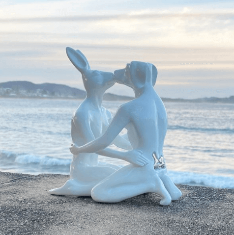 White resin sculpture of animals kissing