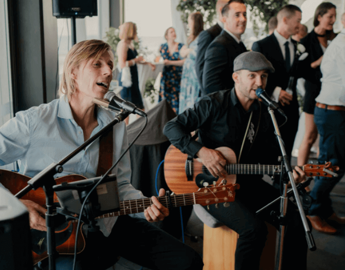 Two men singing and playing guitar