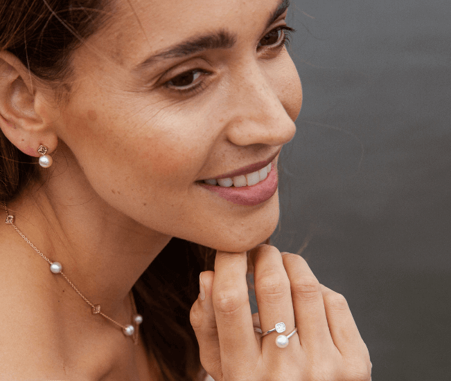 Women wearing pearl earrings, necklace and ring
