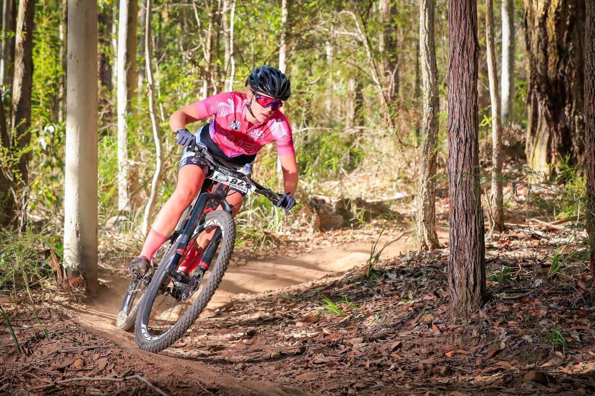 woman cycling through forest