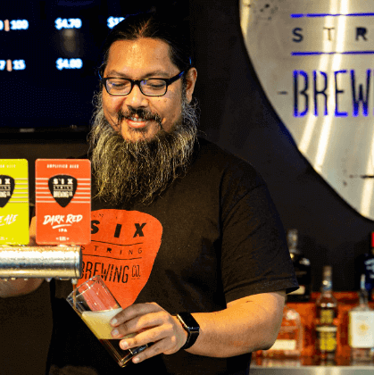 Man pulling pint of beer into glass