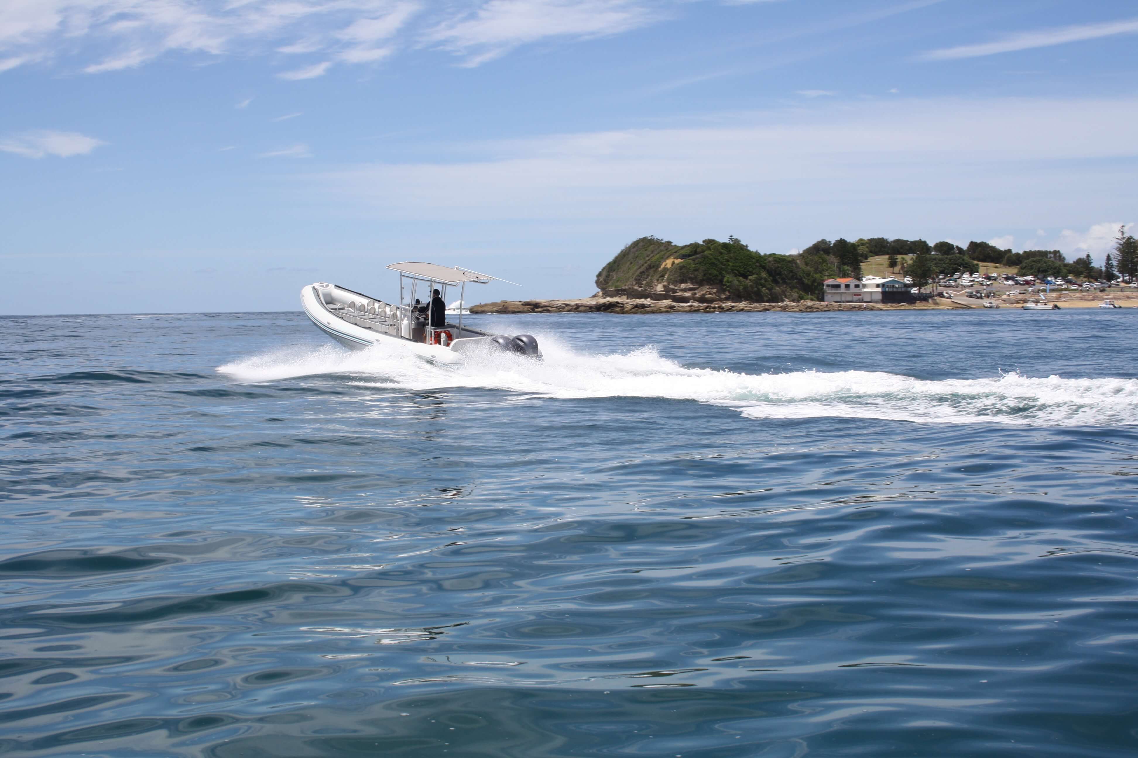 ocean tour by boat embarks into blue ocean horizon