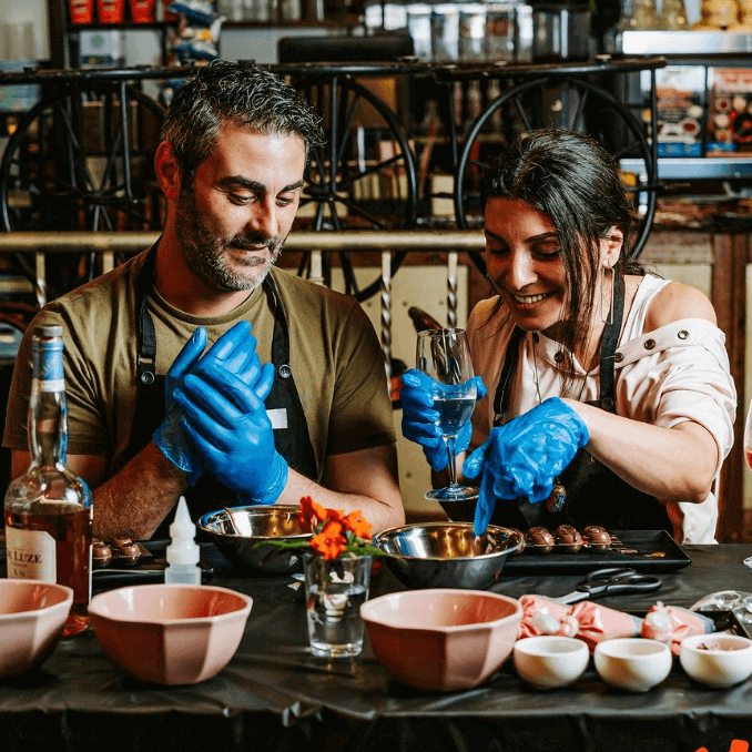 Couple working moulding chocolate