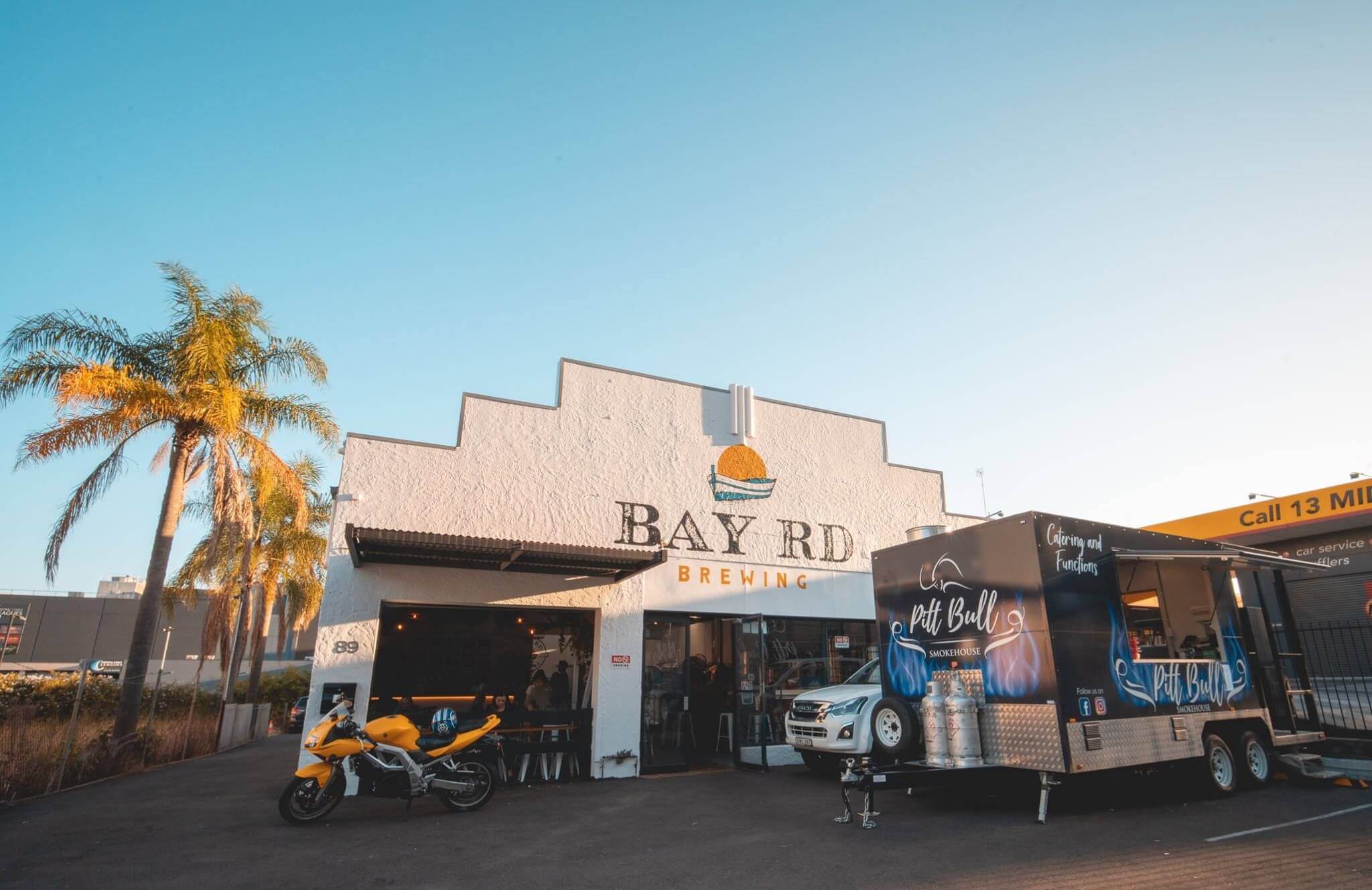 outside bay road venue with blue sky and food truck